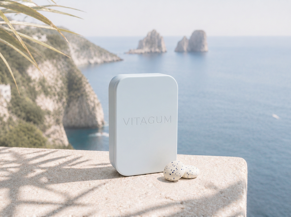 VITAGUM tin on a marble ledge above the Mediterranean
